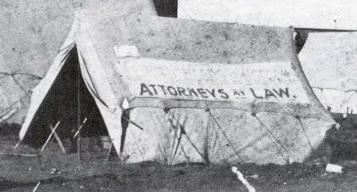 tent with Attorneys at Law advertised on tent wall